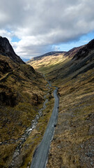 Aerial vertorama of the Honister Pass road winding through rugged English Lake District scenery