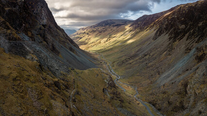 Aerial view of the Honister Pass road winding through rugged English Lake District scenery