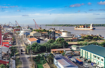Georgetown, Guyana with industrial activity along the waterfront of the Demerara River and a cargo ship in the background