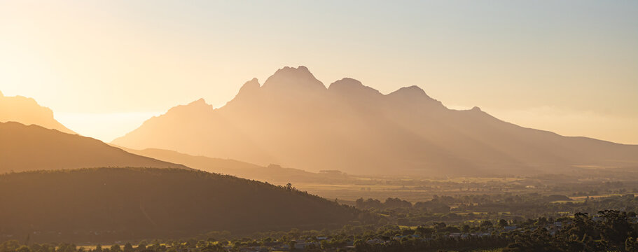 Simon's Mountain, South Africa, mountains silhouettes in sunset light, banner. Golden hour, natural landscape with tonal perspective