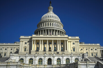 Obraz premium Washington, DC is the capital of the USA. The state capitol buildings in Washington, DC. The Congress in Washington, DC. American flag waving. The Capitol Hill in Washington, DC.