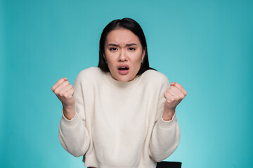 Irritated angry Asian woman girl screams from stress tension problems feels horror hopelessness...