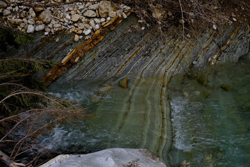 geology river bank rock water strata and layer