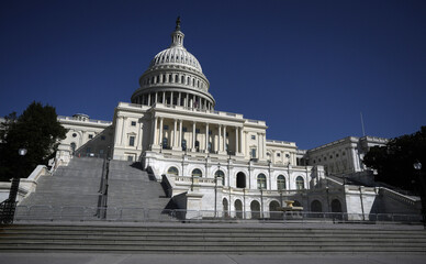 The United States Capitol as a symbol of democracy in Washington, DC. The Capitol building on Capitol Hill. US government. American flag adorns the dome of the historic Capitol. The Senate.
