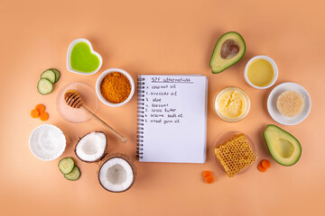 DIY Natural Sunscreen Alternative, Anti-Sunscreen Movement. Natural organic SPF ingredients background with olive oil, coconut oil, cocoa butter, aloe gel, beeswax, carrot seed oil