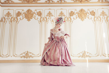 Elegant woman in pink baroque gown poses gracefully in opulent historic interior, blending past and...
