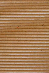 A close-up shot captures the texture of corrugated cardboard with horizontal grooves and slight white paper tears revealing its layered construction