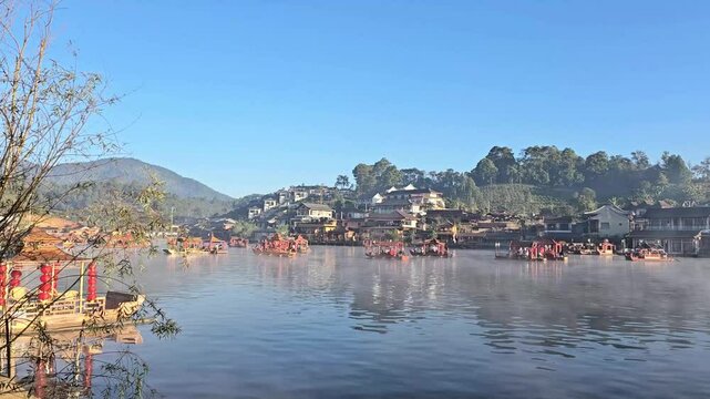 Tourists take antique wooden boat to see lake. January21, 2025 Mae Hong Son province,Thailand. Morning atmosphere of Lee wine Ruk Thai, Ban Rak Thai a Chinese settlement, popular tourist attraction.

