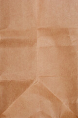 A close-up, top-down shot of a brown paper bag, showing its texture and folds