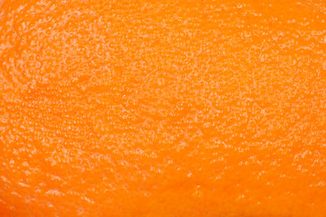 A close-up shot of an orange peel showcasing its textured surface and vibrant color