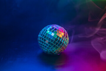A vibrant disco image with a rotating ball, encompassed by colorful swirls The backdrop is a dark gradient with hints of purple, blue, and pink, creating a lively party atmosphere suggestive of fun,