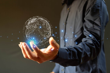Businessman holding globe icon showing global big network connection. Data analysis and business intelligence concept. Points and lines elements concept on world map. Digital link technology.