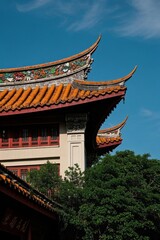 there is a tall building with a red roof and a clock on it