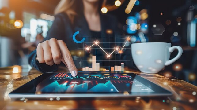 Businesswoman scrolling through data on her tablet at a coffee shop
