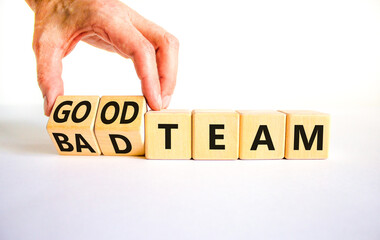 Good or bad team symbol. Concept words Good team Bad team on wooden cubes. Beautiful white table white background. Businessman hand. Business and good or bad team concept. Copy space.