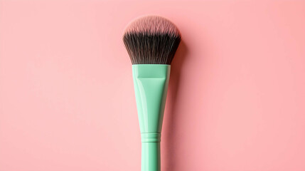 Mint Green Makeup Brush on Pink Background – Minimalist Beauty Tool Concept