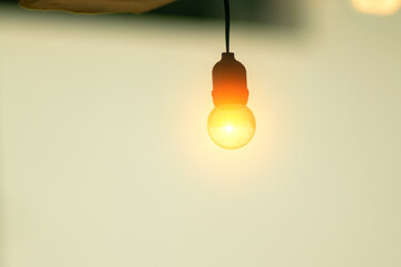 Soft Glow of a Light Bulb Against Light Background