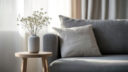 Modern living room with grey couch and wooden table, soft light, minimalistic design, blurred background.