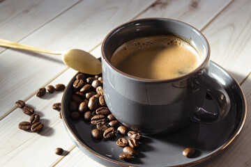 A cozy cup of coffee on a wooden table, with beans and a golden spoon. A perfect scene for coffee lovers.