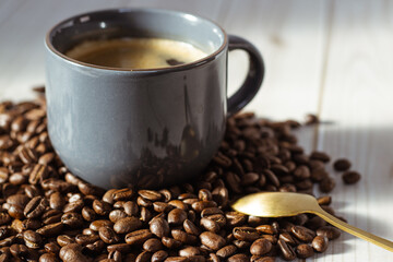 A cozy cup of coffee on a wooden table, with beans and a golden spoon. A perfect scene for coffee lovers.