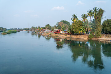 Views of Don Det, 4000 Islands,,a river flowing through a village and lush trees