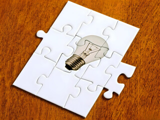 Creative Idea Represented Puzzle Pieces on Wooden Surface. A symbolic representation of creativity...