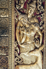 An Intricate Golden Relief Depicting Deities and Graceful Deer in Beautiful Detail