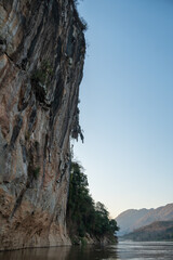 Aerial video shows a river through a scenic Laos landscape with mountains