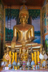 Obraz premium The Majestic Golden Buddha Statue Gracefully Surrounded by Lush Natures Beauty Vientiane, Laos