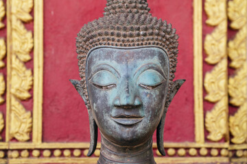 Fototapeta premium A Beautiful Serene Buddha Head Sculpture Featured Against An Ornate and Artistic Background