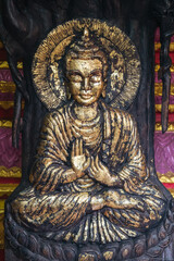 Fototapeta premium The Majestic Golden Buddha Statue Gracefully Surrounded by Lush Natures Beauty Vientiane, Laos