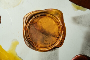 Golden vintage wax seal stamp on old paper