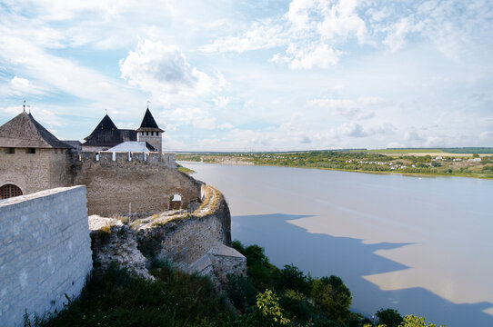 Historic Fortress by a River Under a Tranquil Blue Sky..