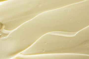 Abstract cooking background of smeared mayonnaise sauce, top view, creativity in cooking.