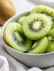 Fresh green kiwi slices arranged in bowl create vibrant, healthy