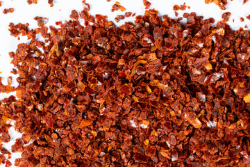 Deep red chili pepper powder close-up texture top view