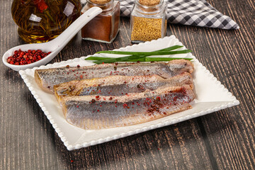 Salted marinated herring fillet with spices