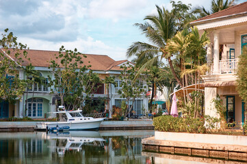 Tranquil Waterfront Scene with Charming Houses and Anchored Boat..