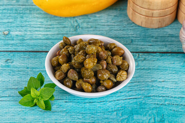 Pickled canned capers in the bowl