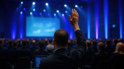 Man raising hand to speak at business or corporate conference.