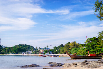 Peaceful Coastal Scene with Boats Docked by a Lush Green Shoreline..