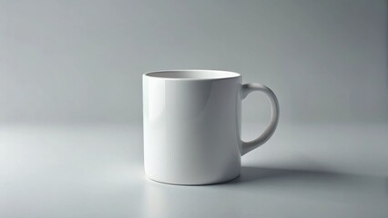 Obraz premium A simple white ceramic mug, perfect for showcasing your designs or brand, sits on a neutral background, ready for customization and personalization.