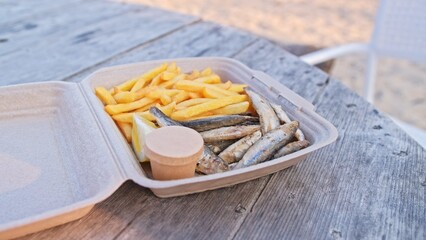 Fried Fish and Chips French Fries Fast Food Snack in Styrofoam Box Sold at Seaside Beach Bar