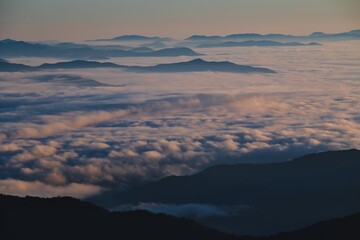 Mountain Ranges Emerging Above a Sea of Clouds at Dawn