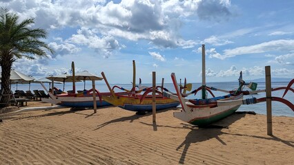 Traditional Balinese fishing boats moored on beach in Sanur, Bali Indonesia