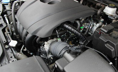 A plastic casing covers the car's gasoline engine. Modern engine detailed stock photo 
