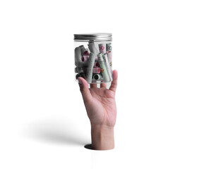 Male hand with banknotes in jar breaks through white paper background.