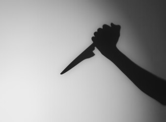 Silhouette of someone holding knife,blur image.