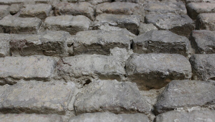 Antique brick stones in a rows texture background. Pattern bricks in old wall stock photo. Ancient architecture materials in a brickwork 