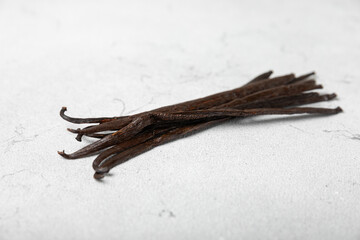 Vanilla pods on a textured background. Vanilla flowers and seeds. vanilla stick bean. Aromatic spicy spice for pastries and desserts. Seasoning. Space for text. Copy Space